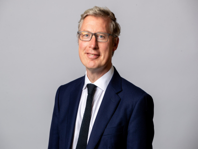 Matt Wilton in a navy suit and tie with white shirt