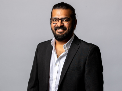 Headshot Aaron roy councillor in black suit jacket and white shirt