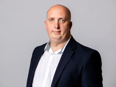 Headshot Adam gaines councillor in black suit jacket and white shirt