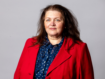 Headshot Amanda napper councillor in blue dress with red overcoat