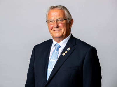Headshot Brian cowie councillor in navy suit jacket, white shirt and light blue tie