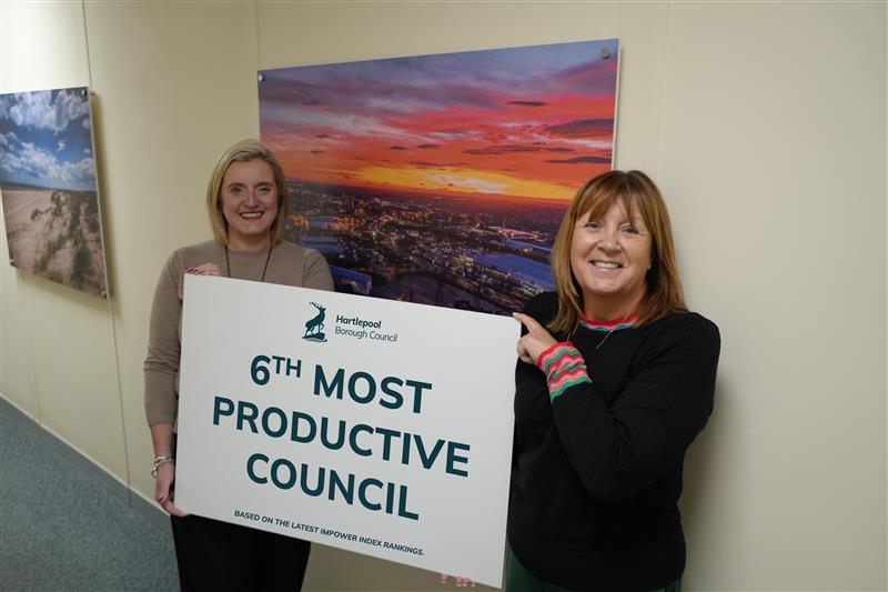 Leader and Chief executive of HBC holding a sign stating 6th most productive council