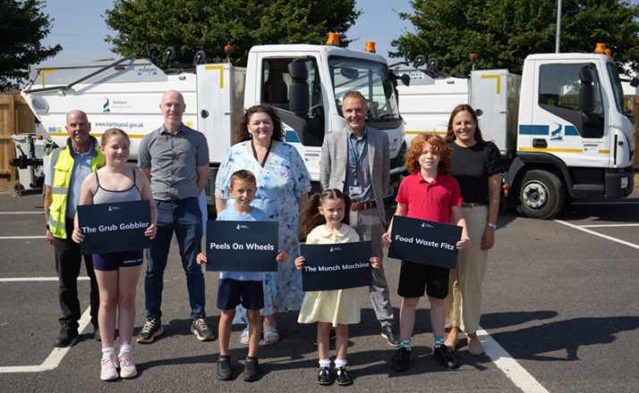 (Back, L-R) Crew Supervisor Darin Aird, Environmental Services Manager Paul Hurwood, Cllr Amanda Napper, Director of Neighbourhoods and Regulatory Services Kieran Bostock and Team Leader- Waste Services Joanne Taylor with the winning pupils.