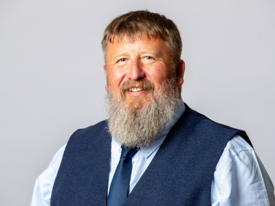 Headshot Graham harrison councillor leader, in light blue shirt with navy waistcoat and matching tie