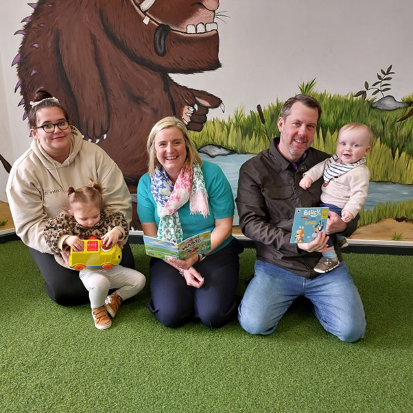 One-year-old Maddie Seago and her mum Emily Vickers exchange their token for a book from Councillor Pamela Hargreaves while Oliver Fulthorp, also aged one, receives his new book from Councillor Gary Allen