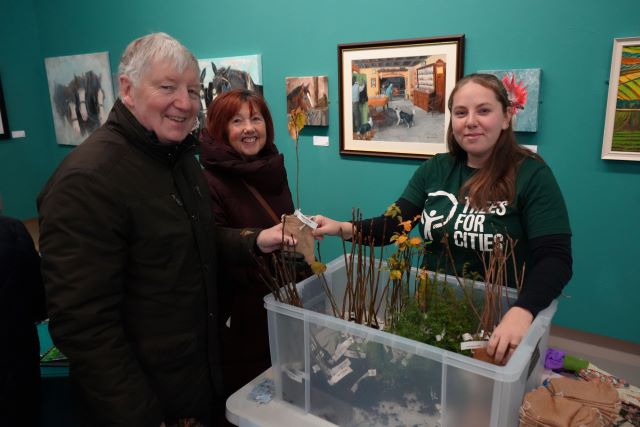 Hartlepool residents George and Christine Krezner receive a crab apple tree to plant in their garden from Charlotte Hardy of Trees for Cities in the free tree giveaway from The Woodland Trust at the launch event