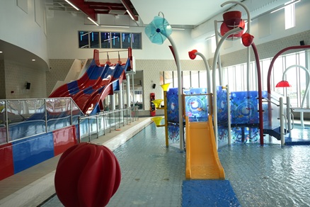 The leisure pool with water play features and a race slide