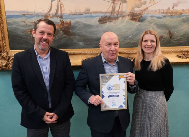 John Lovatt (centre) is congratulated on his award by Councillor Gary Allen and Jill Harrison, the Council’s Executive Director of Adult Services and Public Health