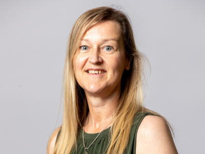 Headshot Leisa smith councillor in green dress with long blonde hair