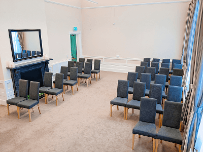 neutral decorated room showing wedding seating
