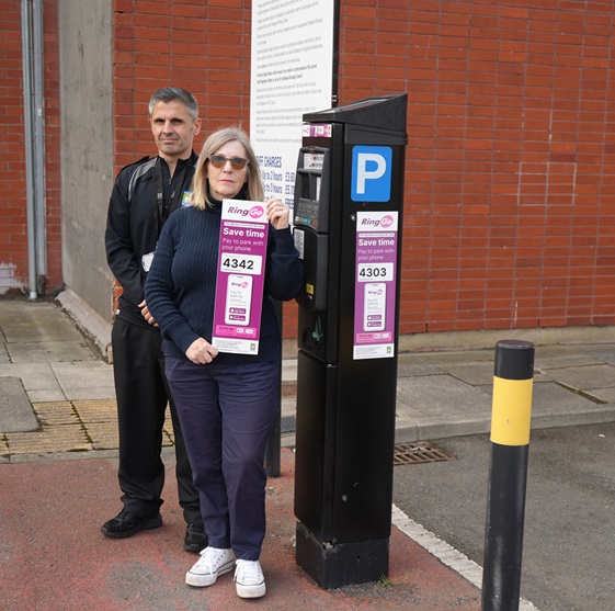 Acting Enforcement Co-ordinator David Riley and Councillor Karen Oliver, Chair of the Neighbourhood Services Committee, with one of the new signs.