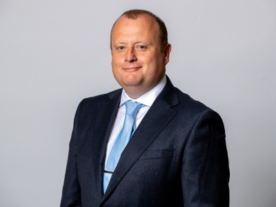 Headshot Scott gaitey councillor in navy suit jacket, white shirt and light blue tie