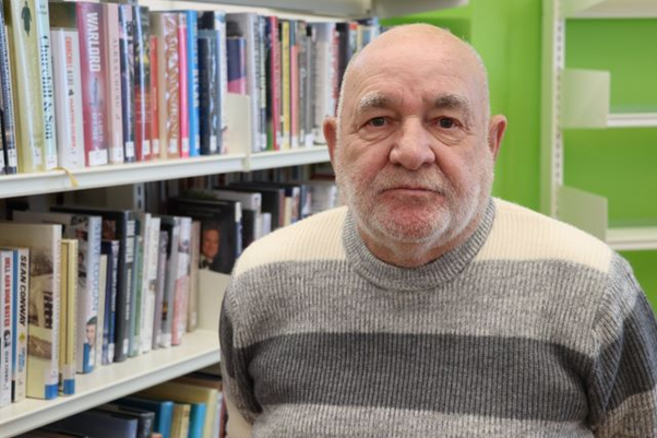Dave MacSween in front of bookcase