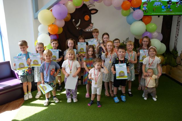 Some of the Summer Reading Challenge champions with their medals and certificates