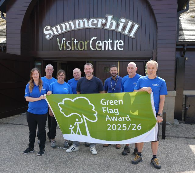Summerhill green flag 2025 councillor gary allen centre in dark blue and staff from summerhill with their green flag