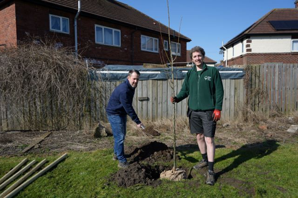 Councillor Gary Allen (left) and Roddy Shaw, Senior Development Manager (England) for Trees for Cities, plant one of the trees