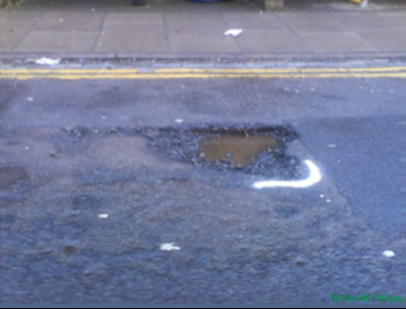 marked pothole on road