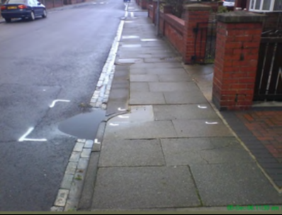 Marked road defect near path