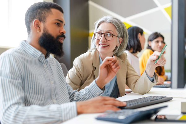 Coworkers collaborating and brainstorming on computer