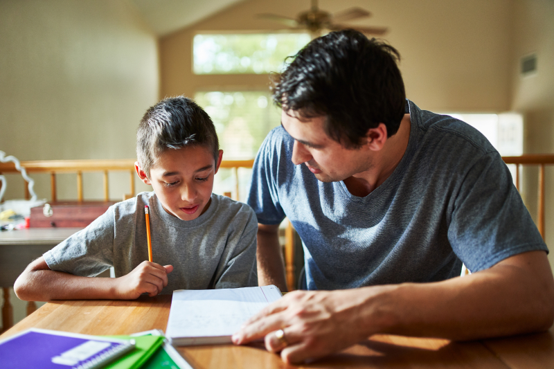 Man helping child with their homework