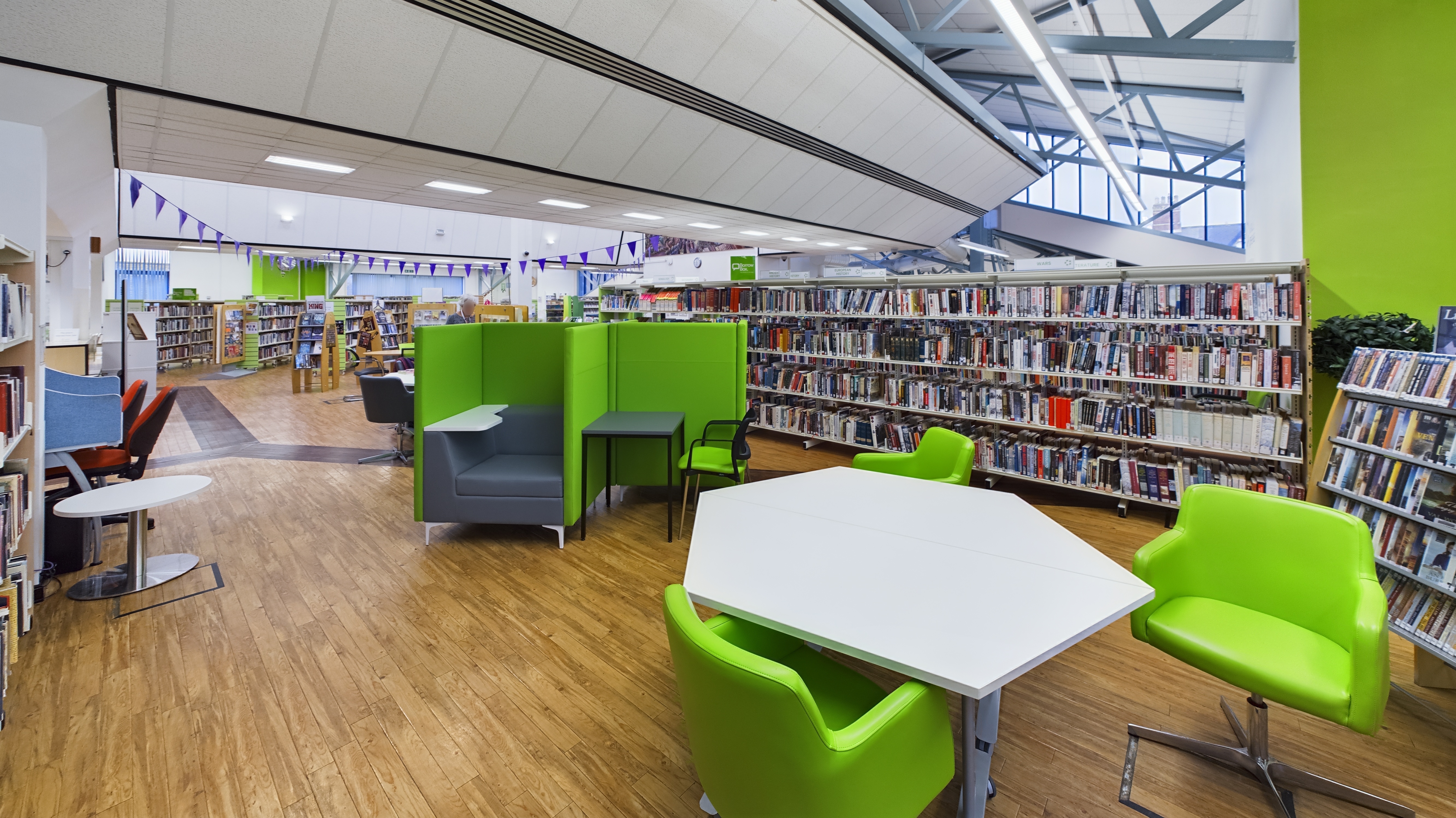 First floor library space with desks and chairs.