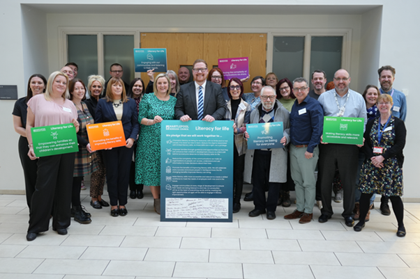 The summit speakers and some of the representatives taking part in the event celebrate the signing of the pledge