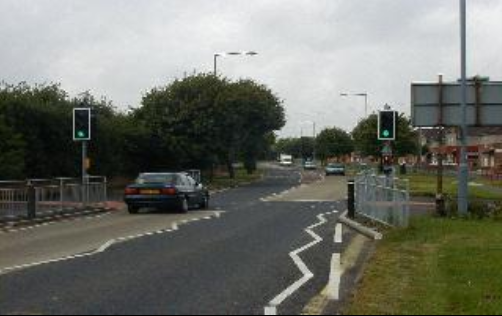 car driving along road with clear road markings